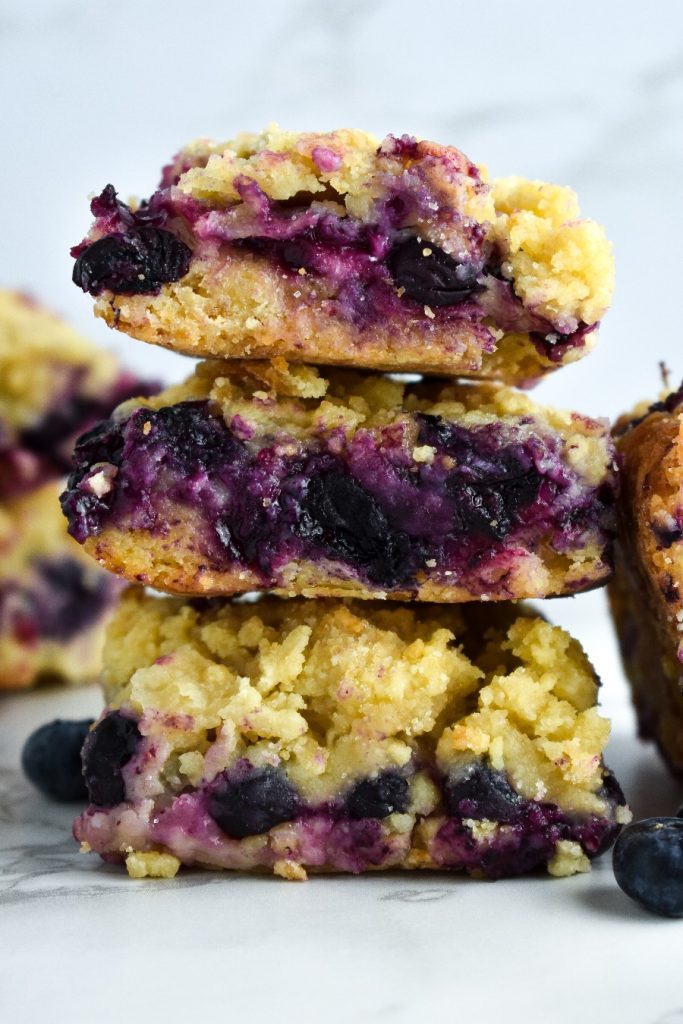Three blueberry crumble bars stacked