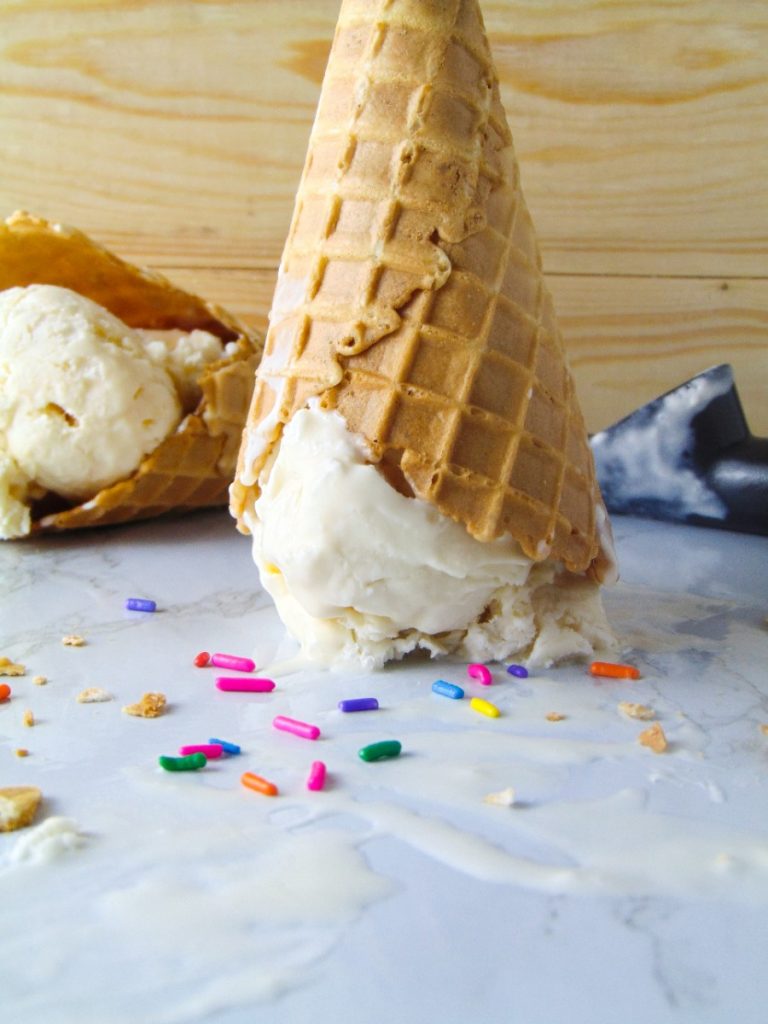 Vanilla ice cream with sprinkles and in a waffle cone