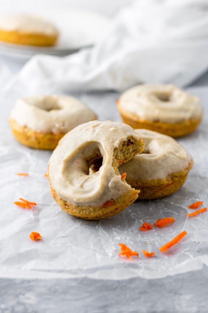 Freshly grated carrots are baked into these cake-like donuts with a cream cheese glaze