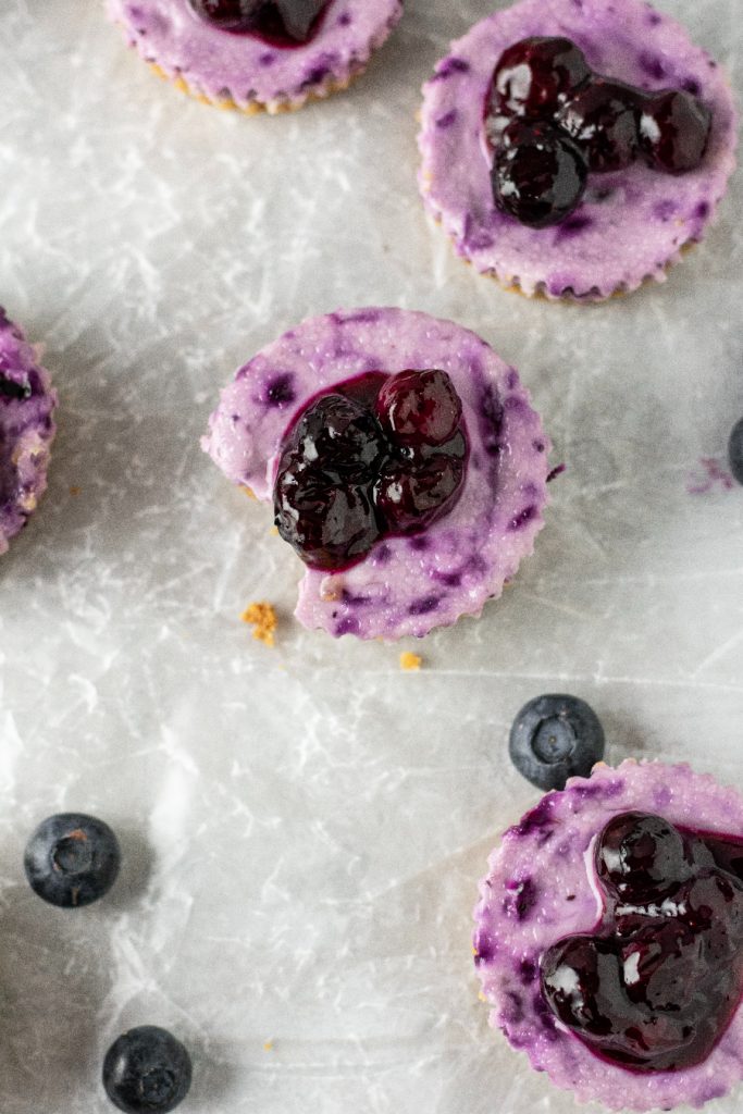 looking down at the blueberry topping on top of the cheesecake bites