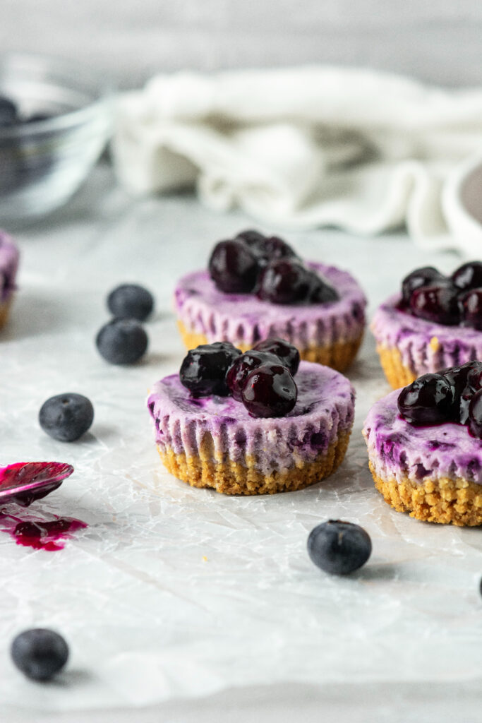 mini blueberry cheesecakes with fresh blueberry topping sauce
