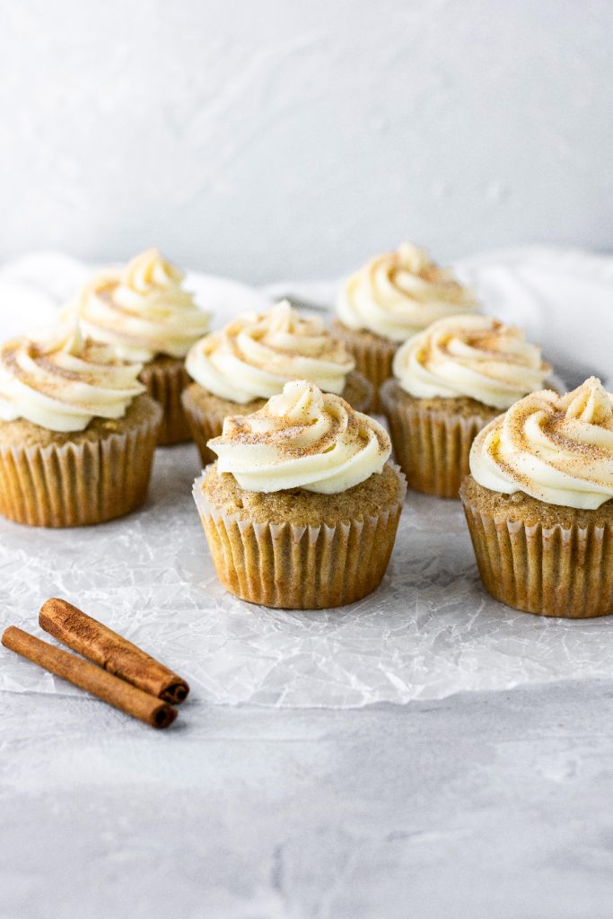 cinnamon sugar coated snickerdoodle cupcakes with cream cheese icing