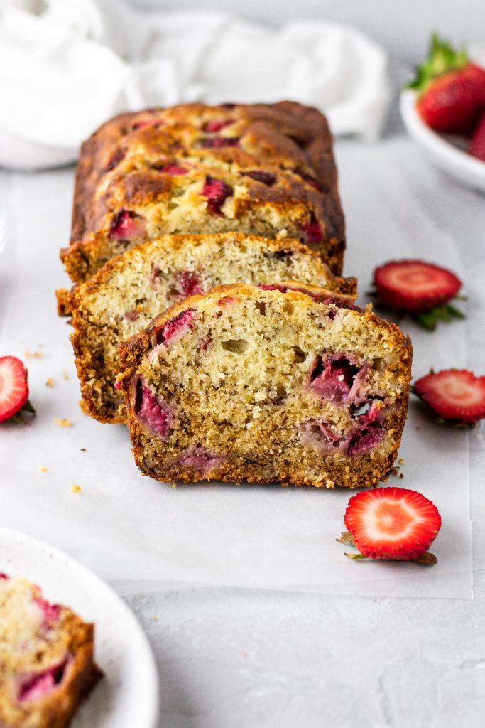 sliced strawberry banana bread that is bursting with fresh strawberries inside