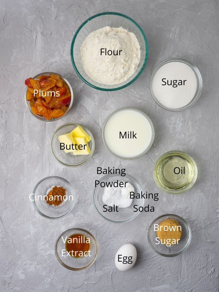 Ingredients needed in plum muffins: flour, sugar, milk, butter, plums, oil, baking powder, baking soda, salt, cinnamon, vanilla extract, egg, and brown sugar