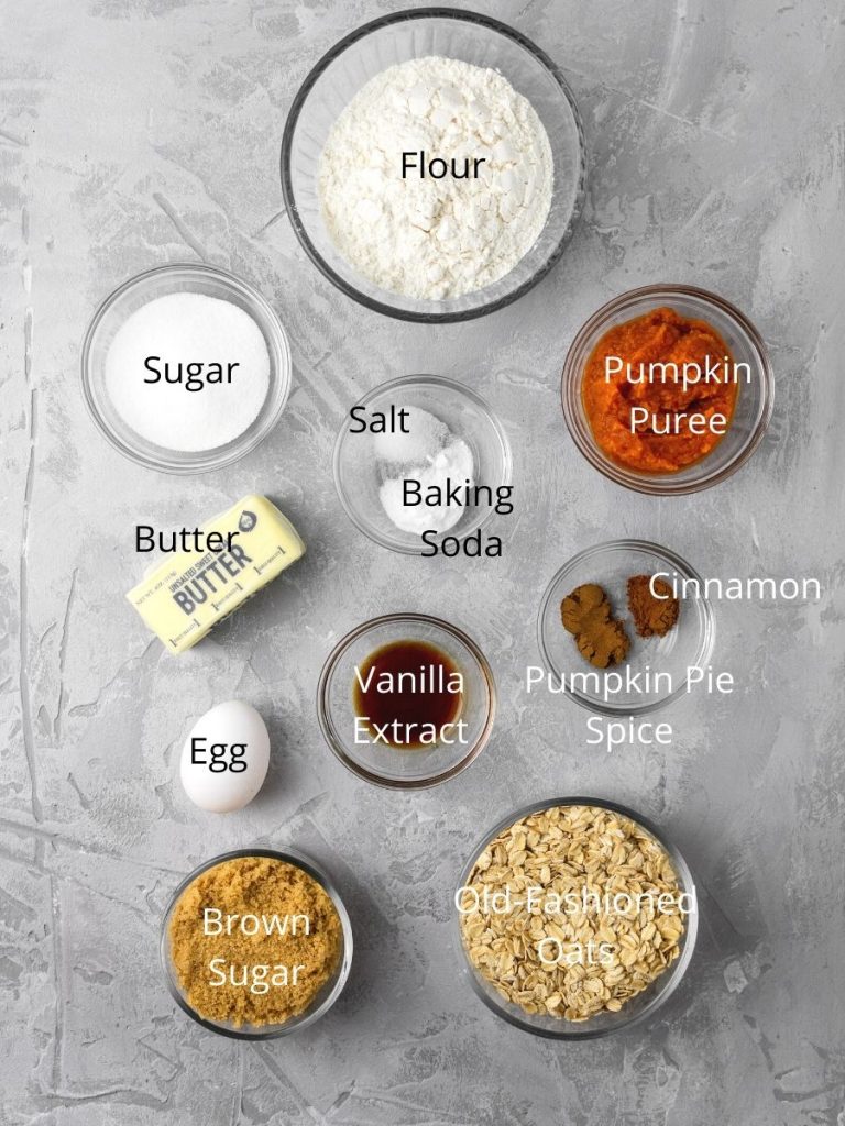 ingredients needed to make oatmeal cookies featuring pumpkin: flour, sugar, butter, salt, baking soda, pumpkin puree, egg, vanilla extract, cinnamon, pumpkin spice, brown sugar, and old fashioned oats