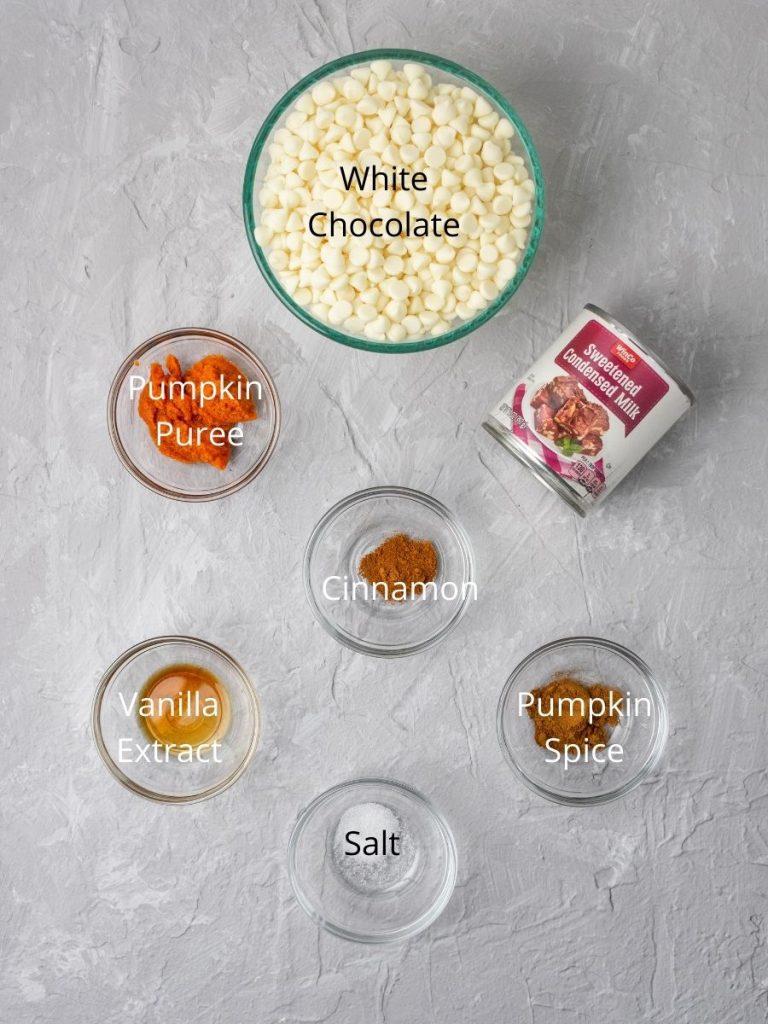 ingredients in pumpkin fudge: white chocolate chips, sweetened condensed milk, pumpkin puree, cinnamon, pumpkin spice, salt, vanilla extract