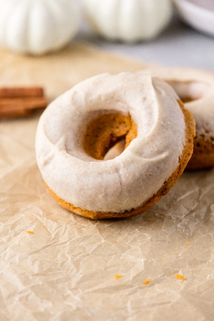 Close up photo of the cinnamon glaze on a pumpkin spice donut.