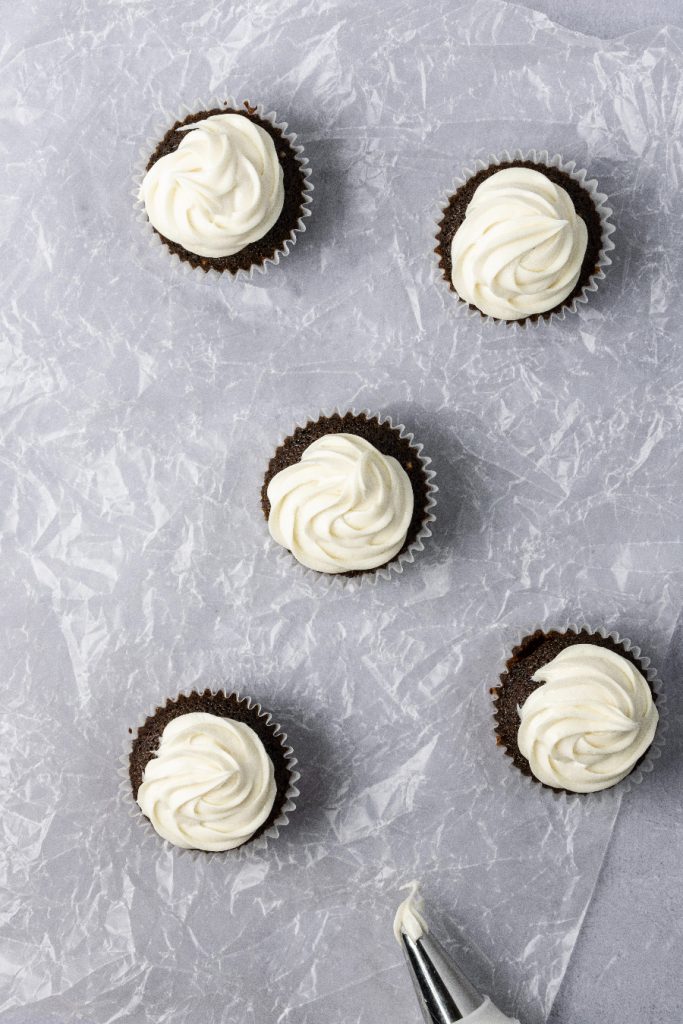 Marshmallow frosting on top of cupcakes.