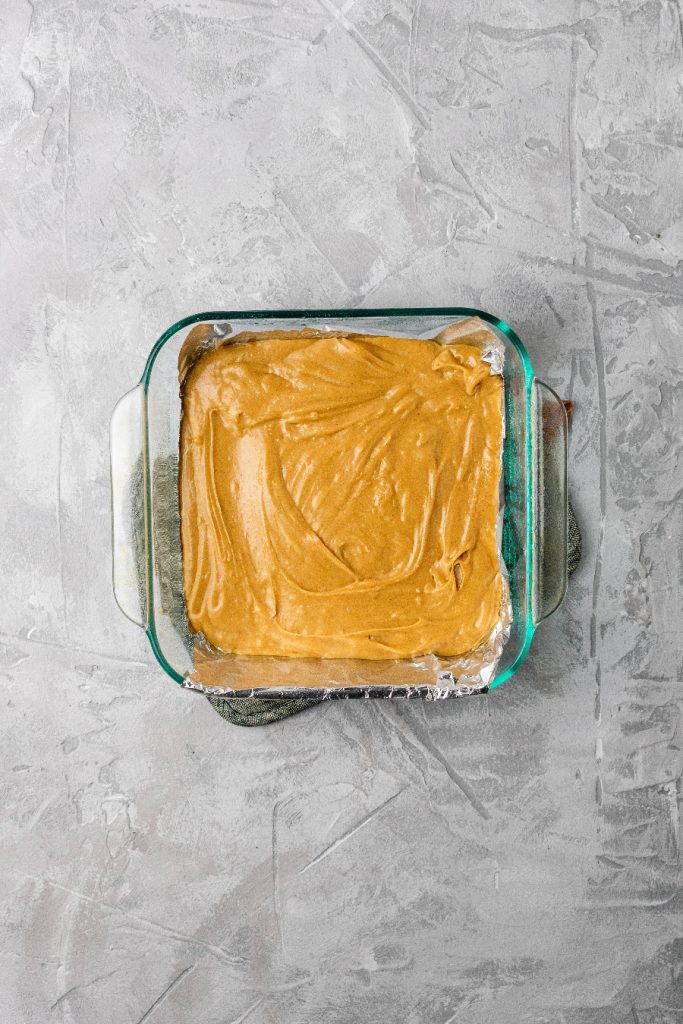 Peanut butter fudge layer in a baking pan.