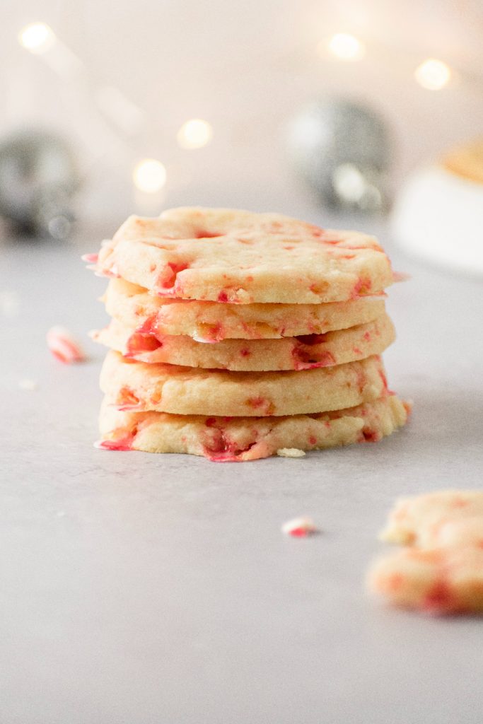 Peppermint shortbread christmas cookies stacked on top of each other.