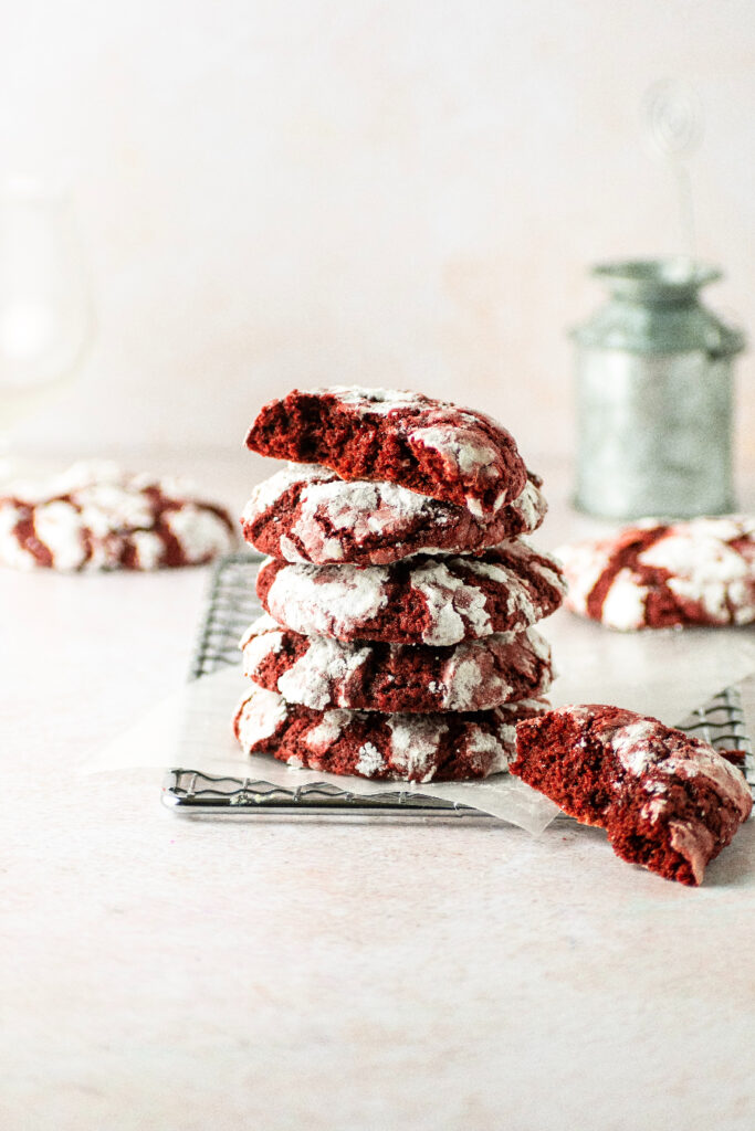 Red crinkle cookies stacked on top of each other.