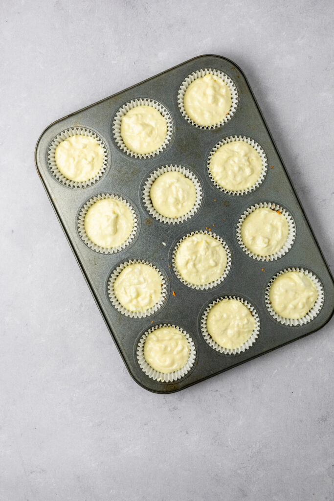 mini lemon cheesecakes ready to bake in a muffin pan.