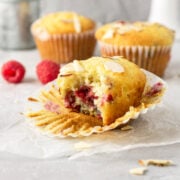 A bite taken out of a raspberry almond muffins.