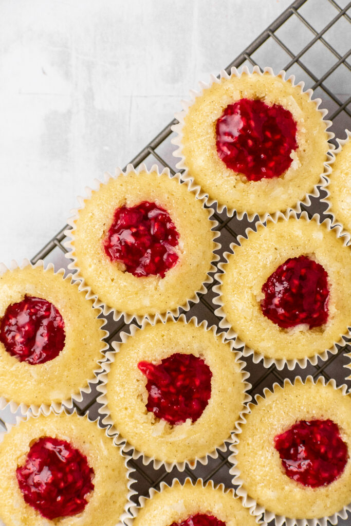 Raspberry filling in the middle of cupcakes.