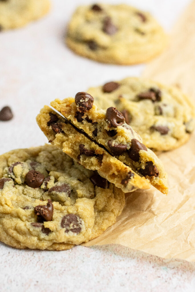 A cookie split in half that's filled with chocolate chips.