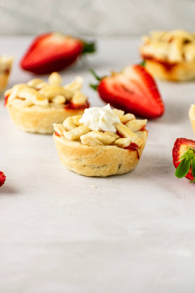 Individual strawberry pies with fresh strawberries.