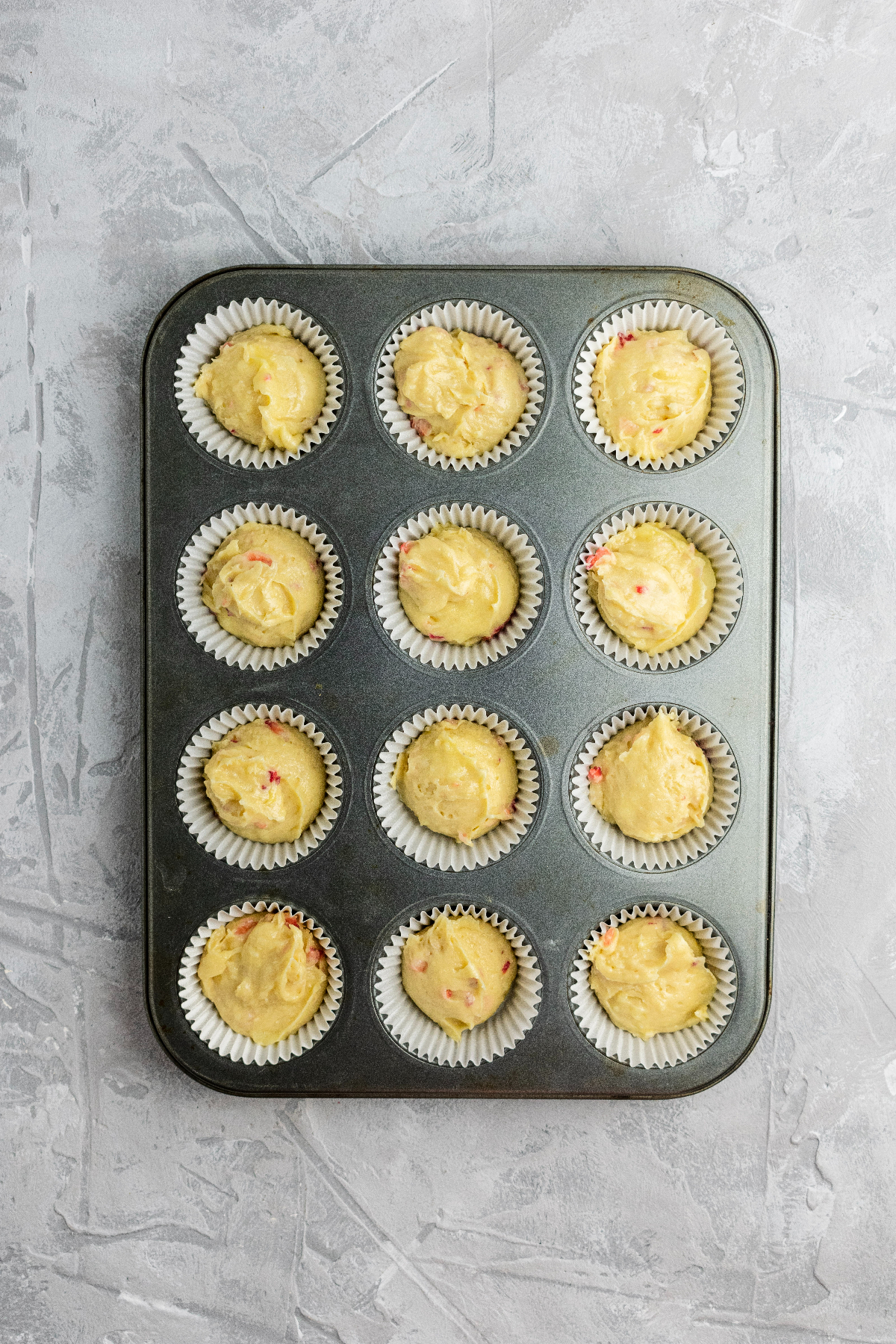 Muffin pan filled with batter and ready to bake.