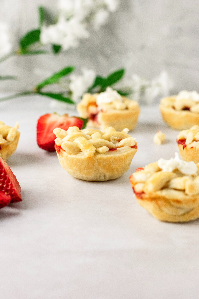 Mini pies with white flowers in the background.