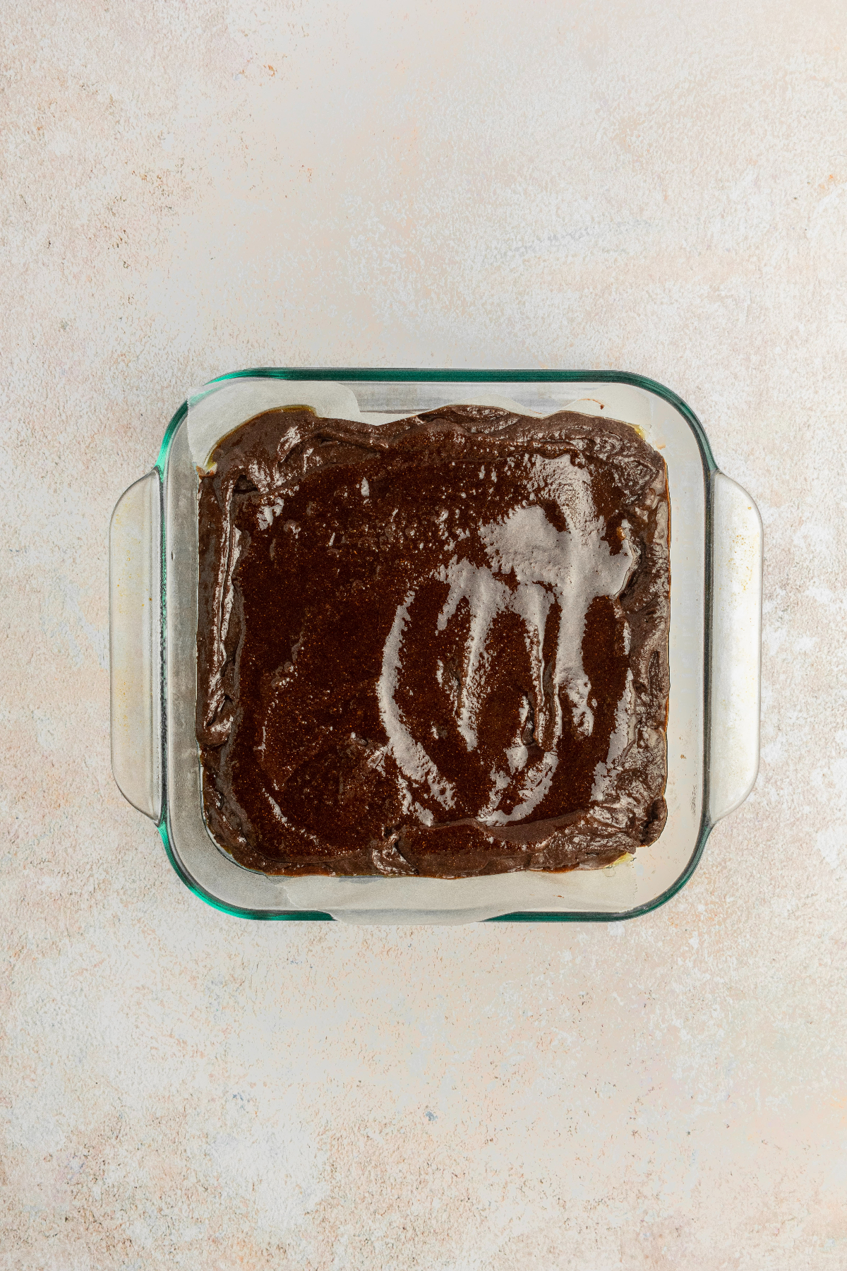 A melted cinnamon topping added to the top of uncooked brownies.