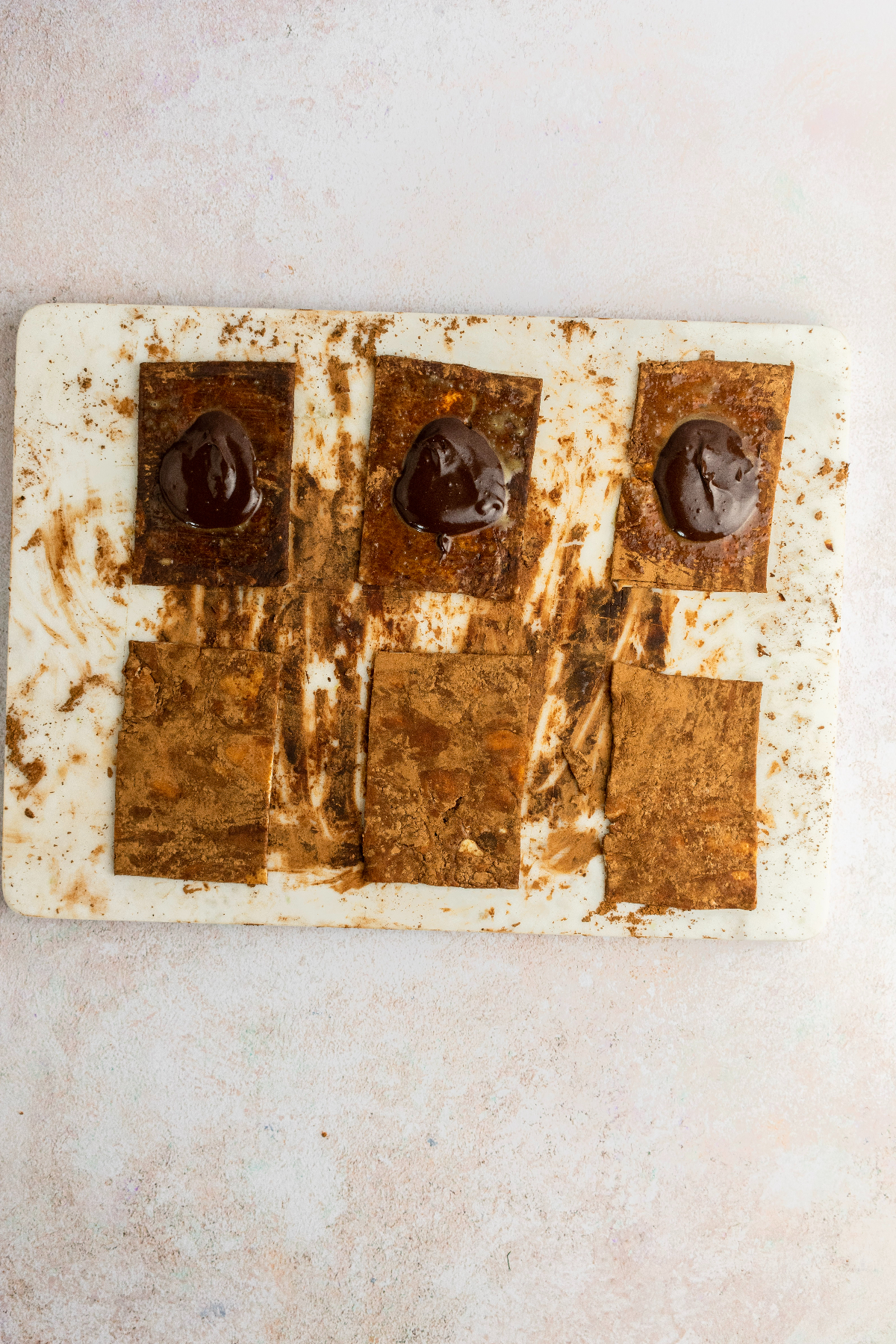 Six dough rectangles with three having chocolate filling.