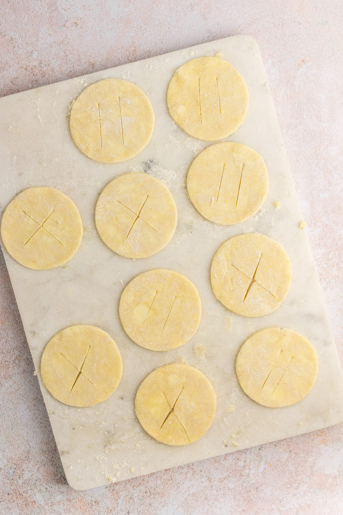 Pie dough circles with slits cut into the tops.