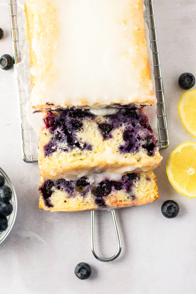 Top view of a blueberry loaf with a lemon icing on top.