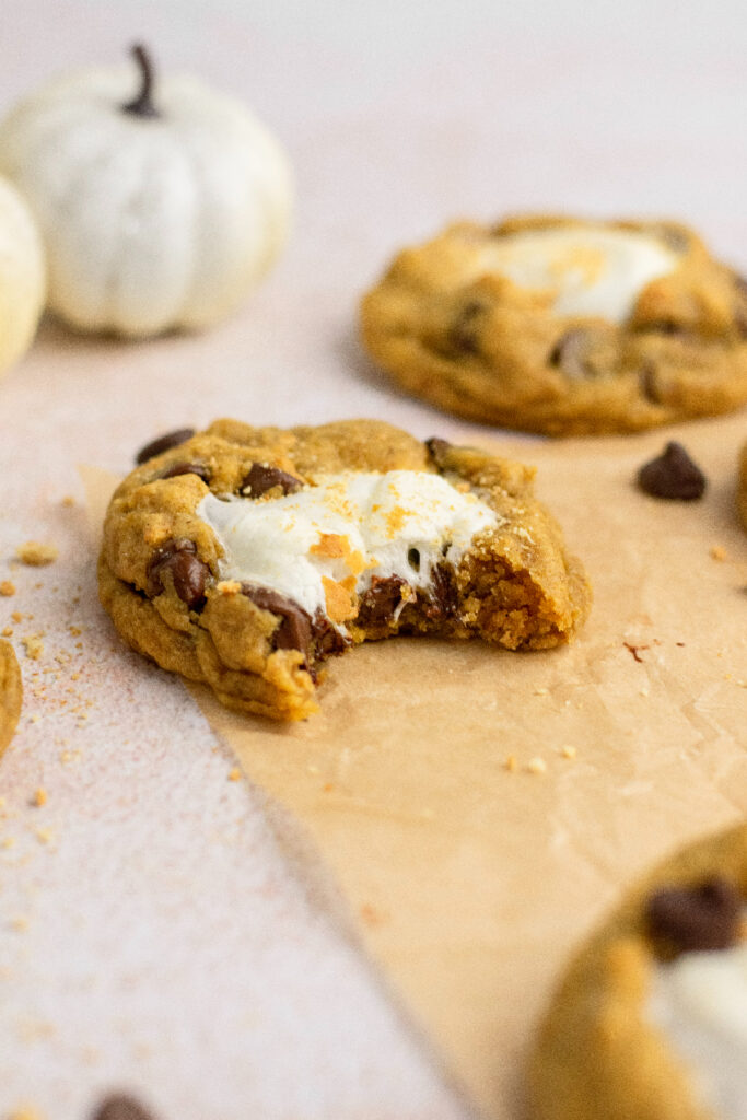 Pumpkin s'mores cookies with a bite taken out of it.