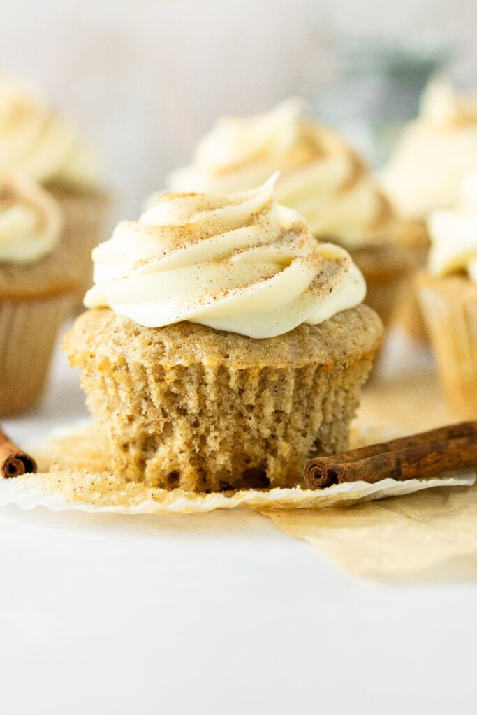 Close up of a cinnamon cupcake with cream cheese frosting.