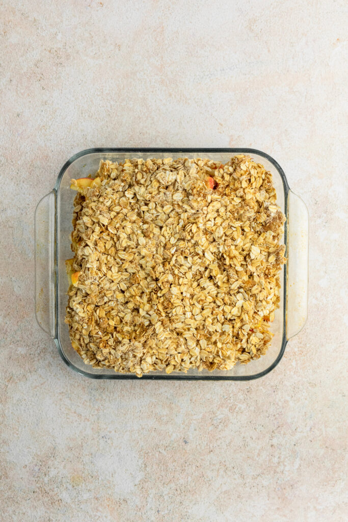 Oat topping in a baking pan ready to bake.