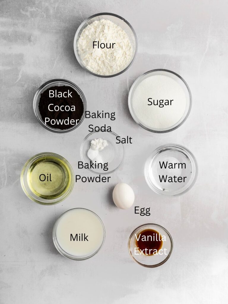 Ingredients needed: flour, black cocoa powder, leavening agents, salt, sugar, water, oil, vanilla, egg, and milk.