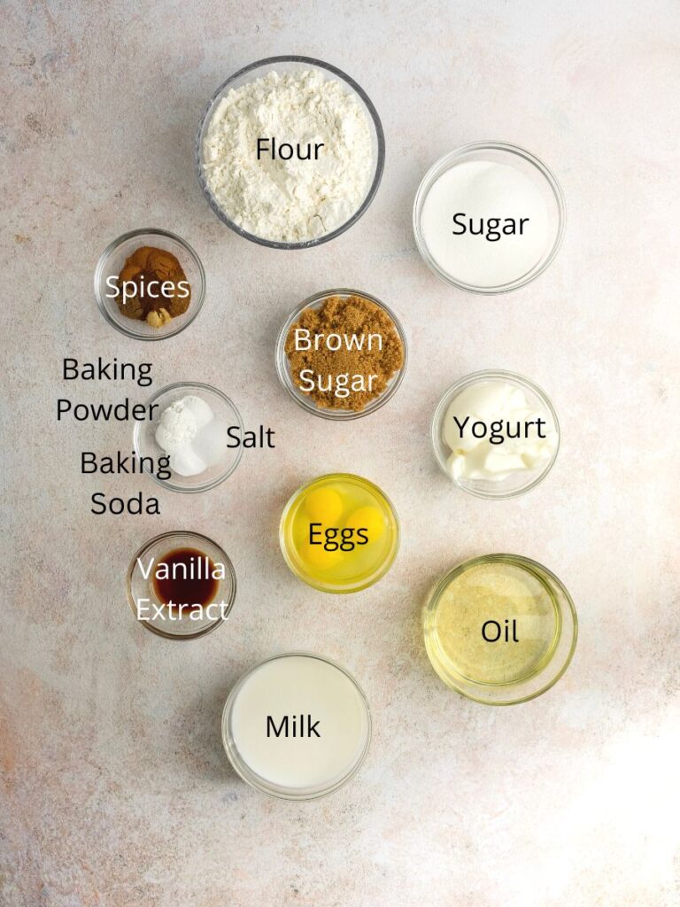 Ingredients needed: flour, sugar, spices, brown sugar, yogurt, baking powder, baking soda, salt, eggs, vanilla, milk, and oil.