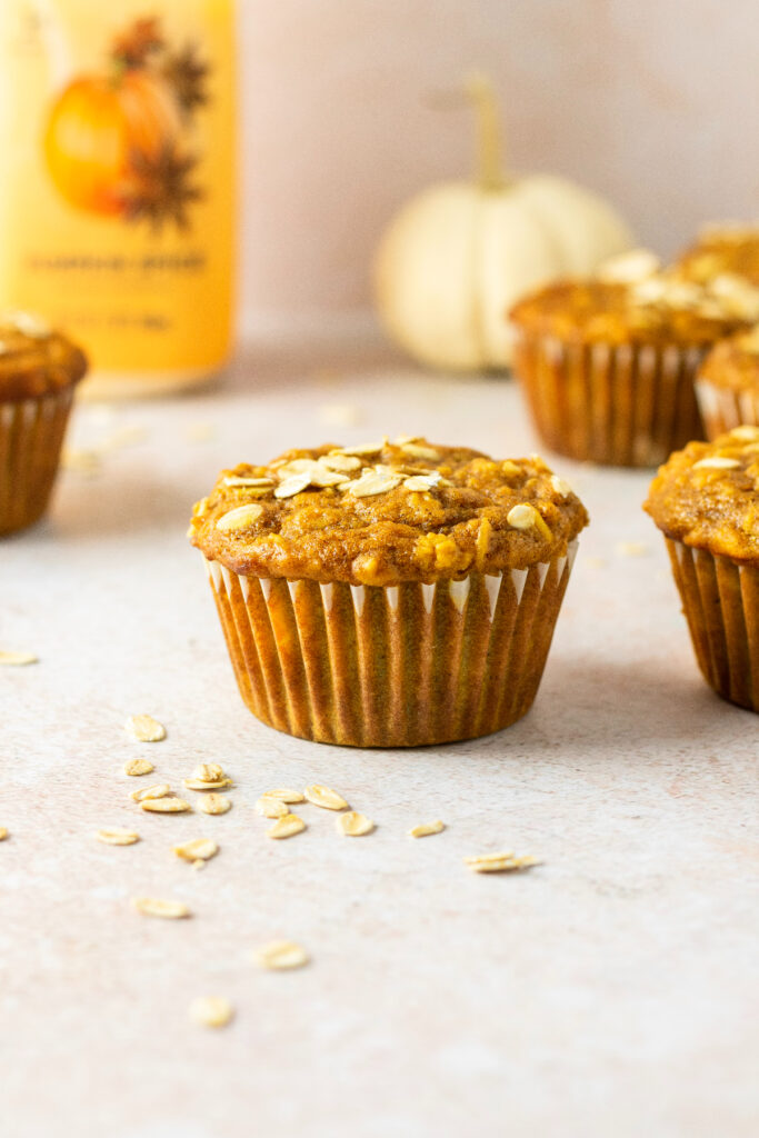 Pumpkin muffins with oats on the ground.
