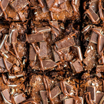9 brownie bars topped with melted chocolate and mint candies.