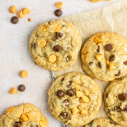 Butterscotch chocolate chip cookies on a brown piece of parchment paper.