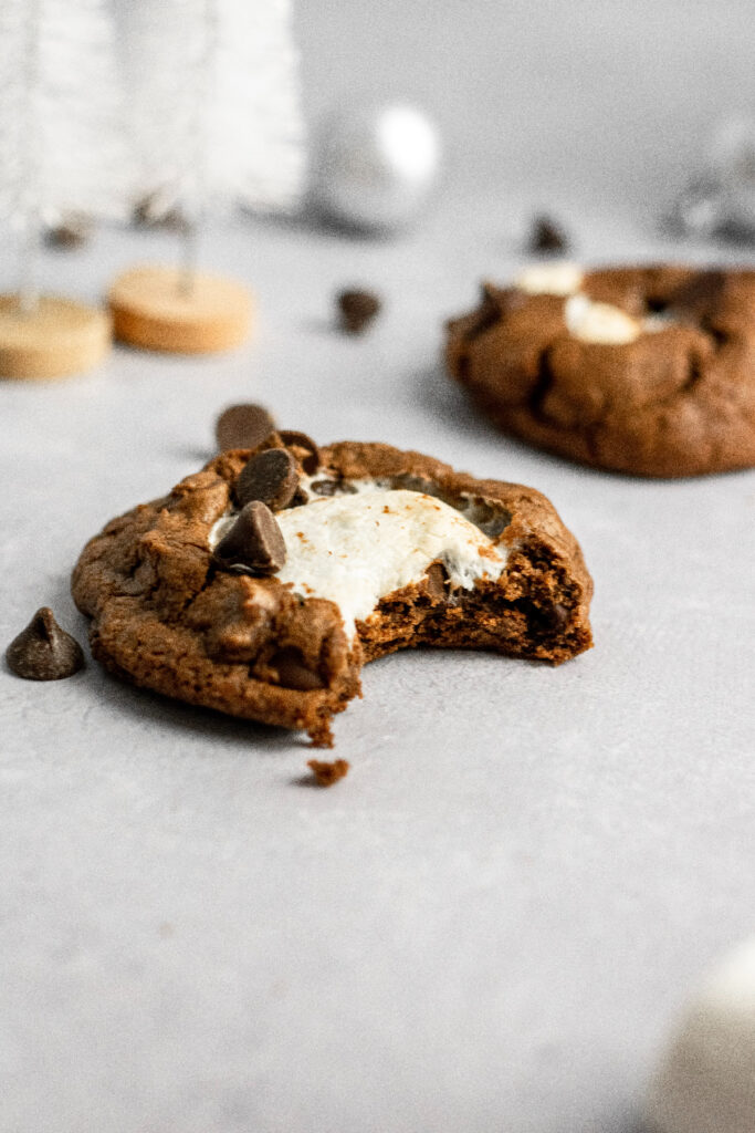 Chocolate marshmallow cookie with a bite taken out of it.