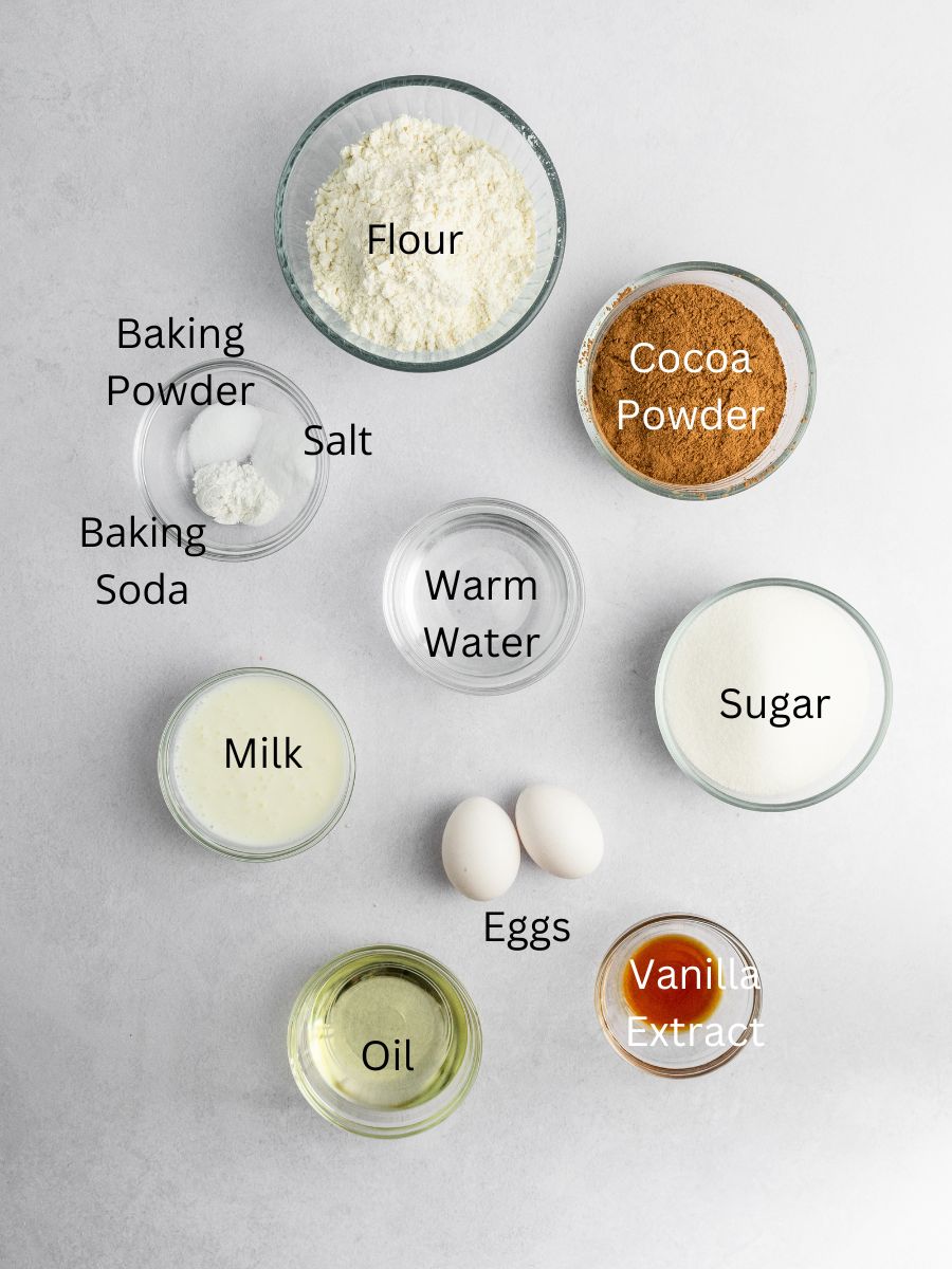 Ingredients needed: flour, cocoa powder, leavening agents, salt, water, milk, oil, eggs, and vanilla.