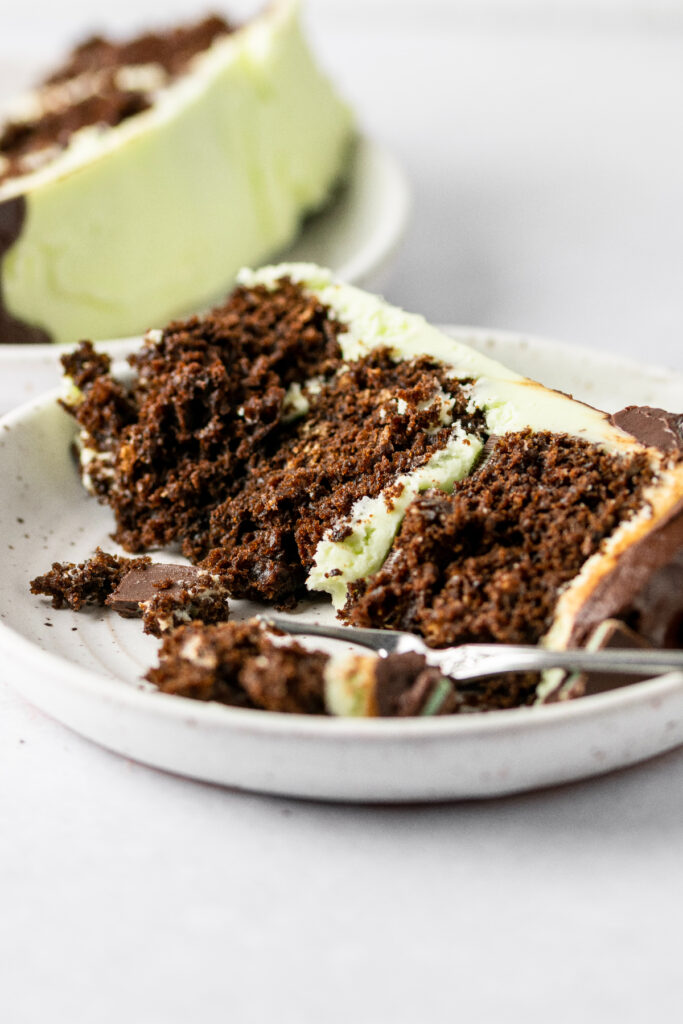 Andes mint cake slice on a white plate with a fork.