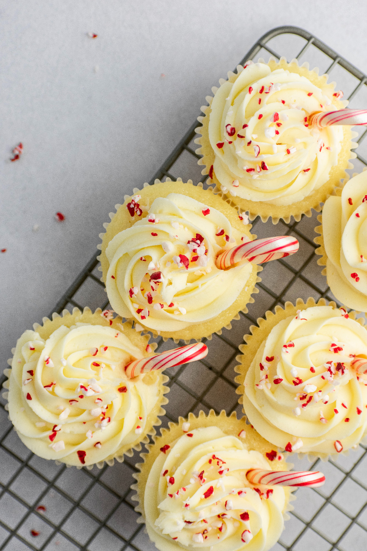 Peppermint frosted cupcakes with candy canes.