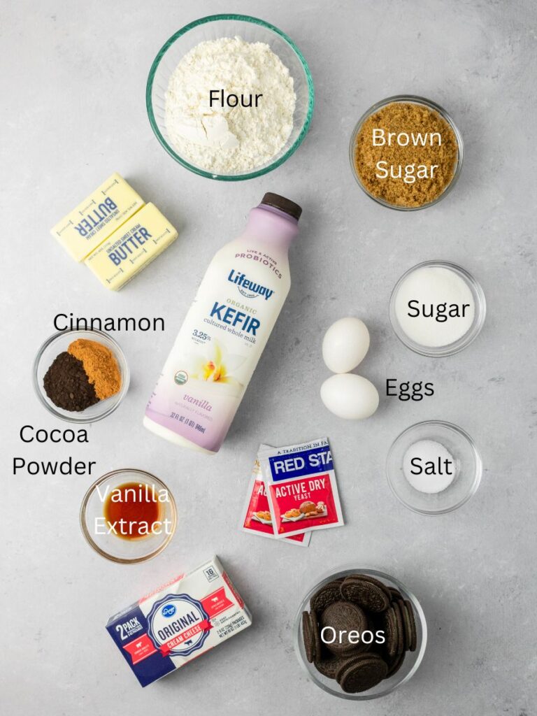 Ingredients needed: flour, brown sugar, butter, kefir, sugar, cocoa powder, cinnamon, eggs, yeast, vanilla, salt, cream cheese, and oreos.