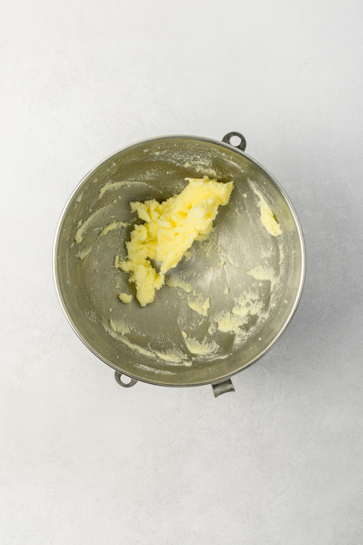 Creamed butter and sugar in a stainless steel bowl.