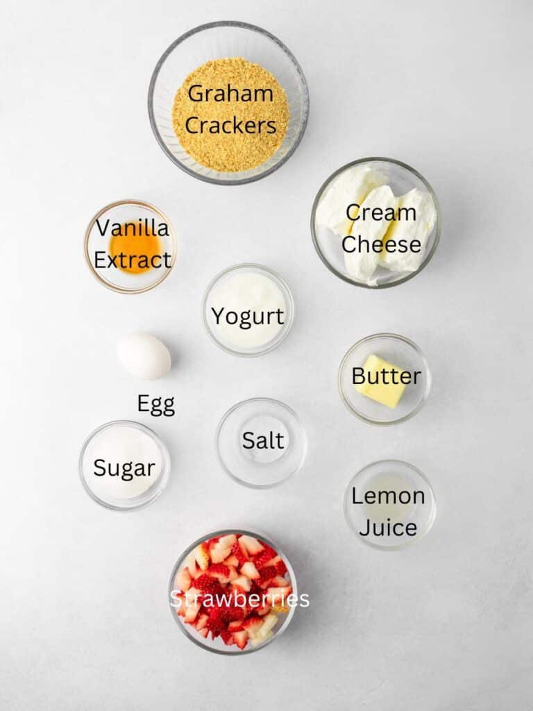 Ingredients needed: graham crackers, vanilla, cream cheese, yogurt, sugar, butter, salt, egg, lemon juice, and strawberries.
