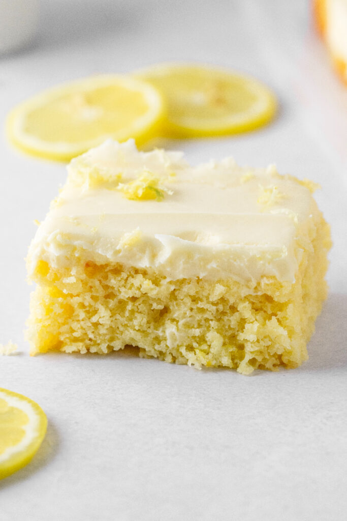 Lemon cake slice with lemon zest on top.
