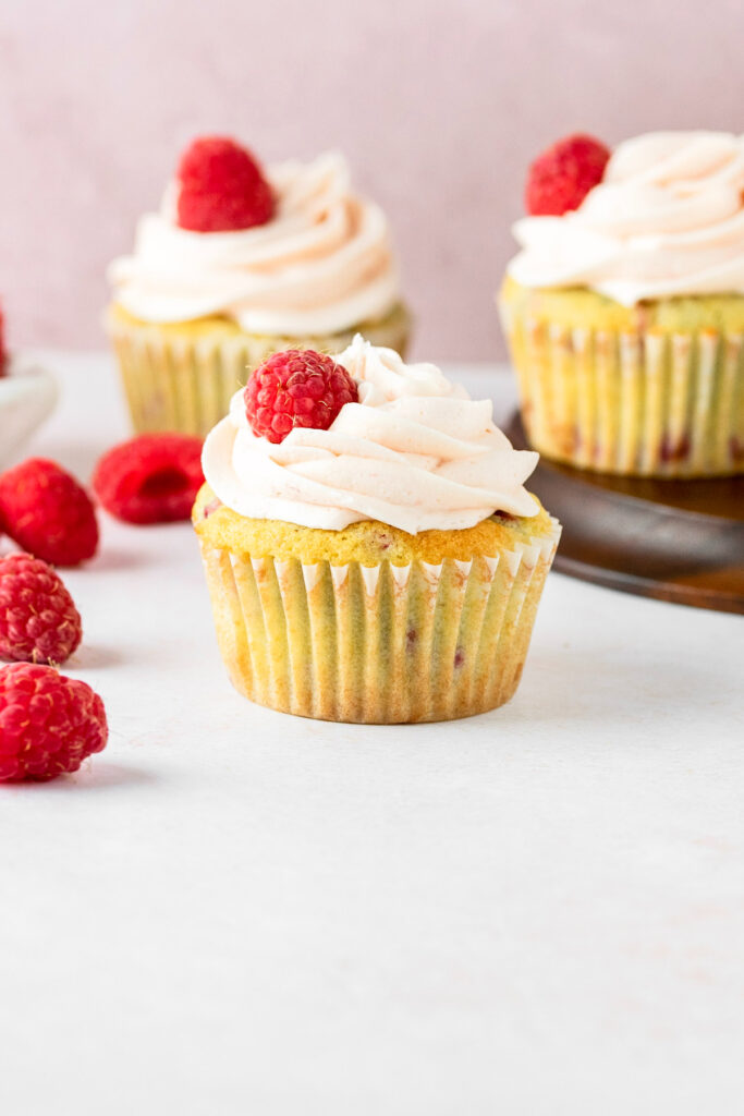 Vanilla cupcake with fresh raspberries.