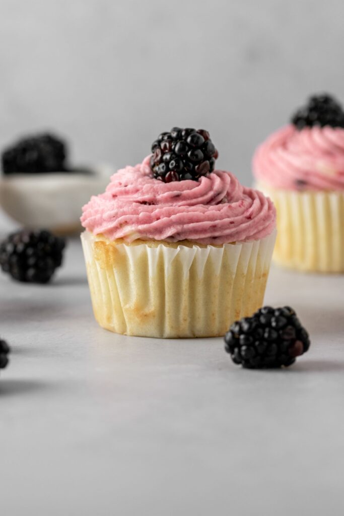 Vanilla cupcake with blackberry buttercream frosting.