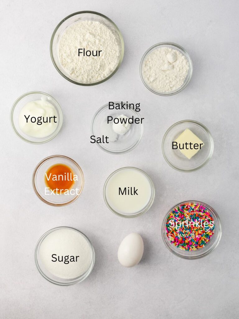 Ingredients: flour, yogurt, baking powder, salt, butter, vanilla, milk, sprinkles, egg, sugar, and powdered sugar.