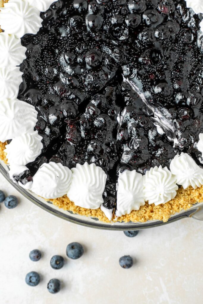 Blueberry no bake pie with slices cut into it.