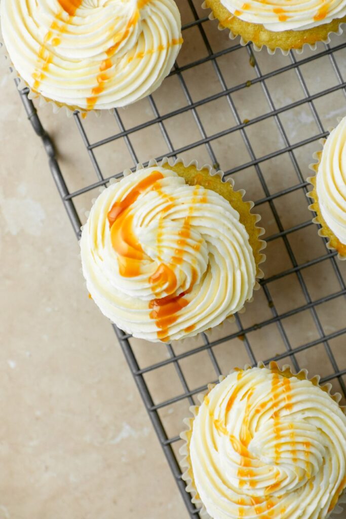 Caramel buttercream on top of cupcakes with caramel drizzle.