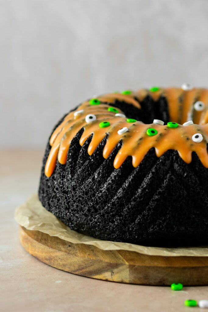 Halloween bundt cake with white chocolate orange glaze and sprinkles on top.