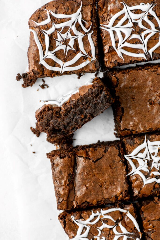 Spiderweb chocolate brownies on parchment paper.