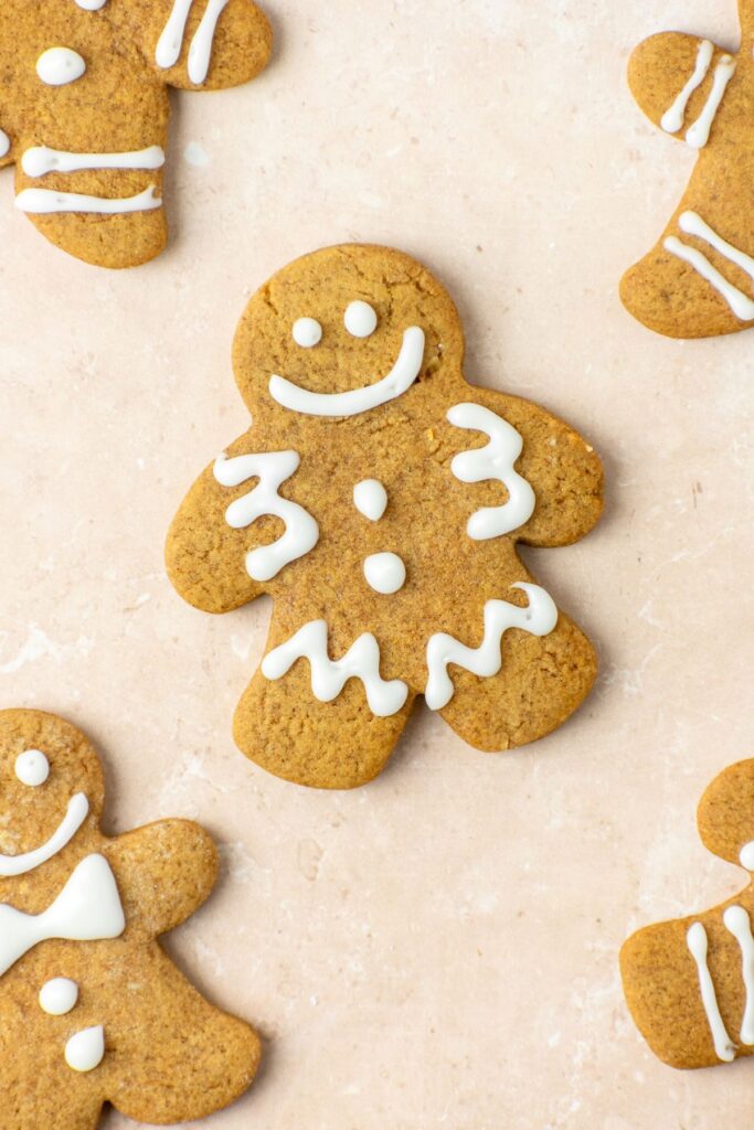 Smiling gingerbread men cookies decorated with a vanilla frosting.